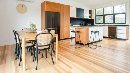 a kitchen and dining room with a table and chairs at Naturally Shoreham in Shoreham