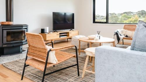 a living room with a couch and a tv at Naturally Shoreham in Shoreham
