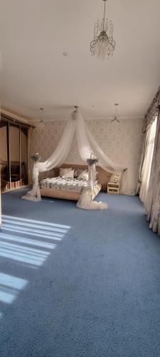 a bedroom with a bed with a mosquito net at Готельно-Ресторанний Комплекс Три Бобри in Litowiż