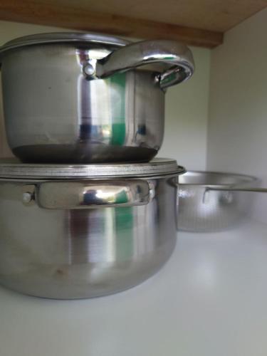 two pans sitting on a counter in a kitchen at Villa with Titiwangsa Hill View in Kerling