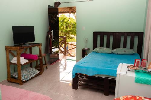 En eller flere senger på et rom på Pousada & Camping Recanto dos Anjos Azuis