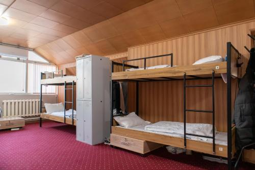 a room with two bunk beds in a building at Almaty Backpackers in Almaty