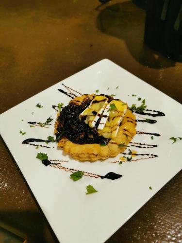 a white plate with a dessert on a table at Nedile Lodge in Welgevonden Game Reserve