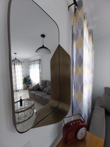 a mirror hanging on a wall in a living room at Villa Stefi in Playa Blanca