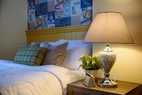a lamp on a night stand next to a bed at Waterfront Self Catering Houses in Carrick on Shannon
