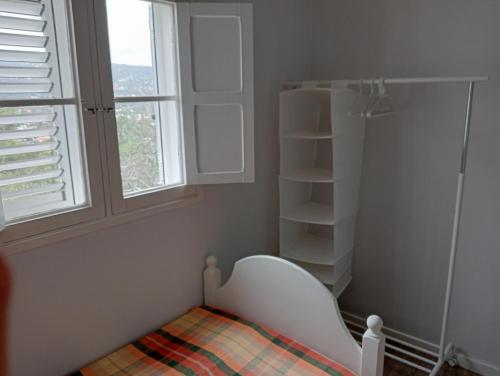 a small bedroom with a bed and a window at Casa Carmelita in Las Palmas de Gran Canaria