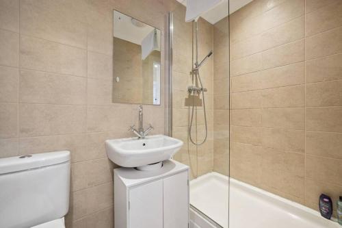 a bathroom with a sink and a toilet and a shower at (G4) Luxurious 2 Bed Blythswood Flat in Glasgow