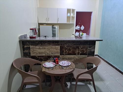 a kitchen with a table with two plates on it at Sweet Home- No Egyptian in Hurghada