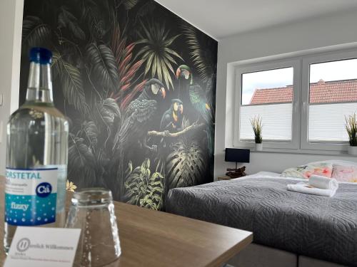 a bedroom with a wall with a mural of birds at HAMA Design Homes Paderborn 4 Apartments in Paderborn