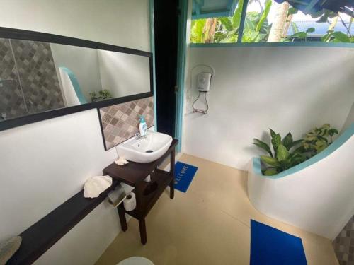 a bathroom with a sink and a mirror at DJs Beach Resort in Union