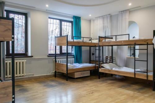 a room with four bunk beds in it at Almaty Backpackers in Almaty