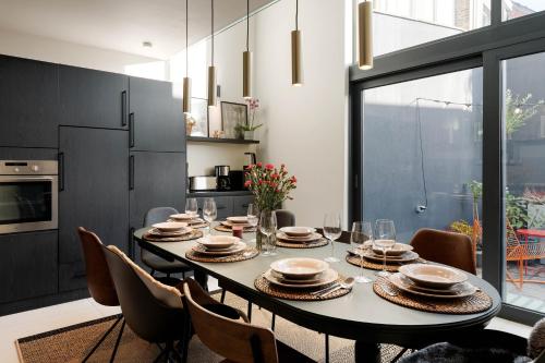 a dining room with a table and chairs at Spacious & Chic House in Center in Kortrijk
