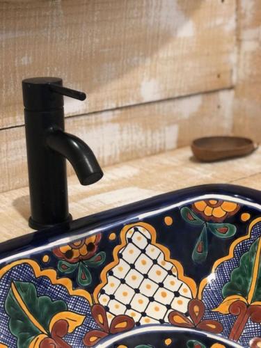 a colorful sink with a faucet on a counter at Villa Tigo T3 Colibri in Sainte-Luce