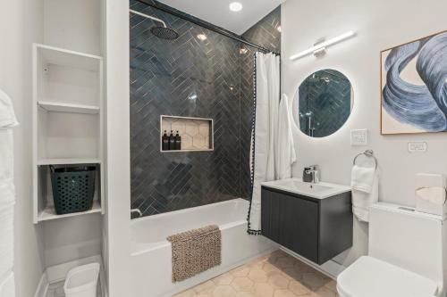 a bathroom with a shower and a sink and a toilet at Passyunk Square Spacious 1 BR Oasis- Huge Deck in Philadelphia