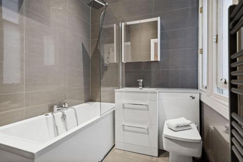(G5) Grand 1 bed Blythswood Apartment في غلاسكو: حمام مع حوض ومرحاض ومغسلة
