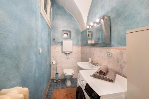 a bathroom with a white sink and a toilet at Casa Bianca in Bormio