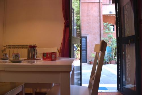 a kitchen with a counter and a table and a window at Palazzo Velli Suites in Rome
