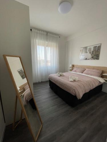 a bedroom with a large bed and a mirror at Exphome in Novate Milanese
