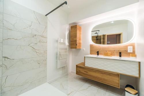 a bathroom with a sink and a mirror at Belle longère familiale - Trémuson in Trémuson