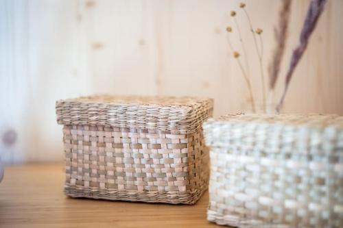 two baskets sitting on top of a wooden table at The Swiss Bijou / Alpine Retreat in Stans