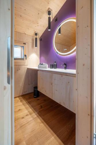 a bathroom with a sink and a mirror at The Swiss Bijou / Alpine Retreat in Stans