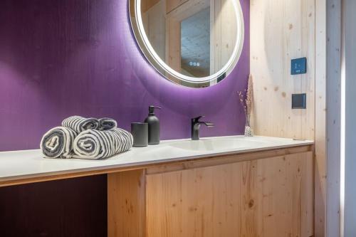 a bathroom with a sink and a mirror at The Swiss Bijou / Alpine Retreat in Stans
