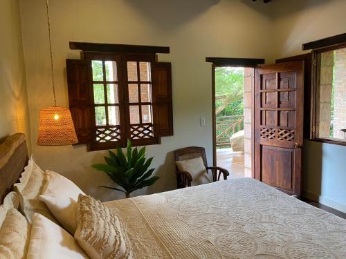 a bedroom with a bed and a sliding glass door at Mentto Hotel in Guaduas