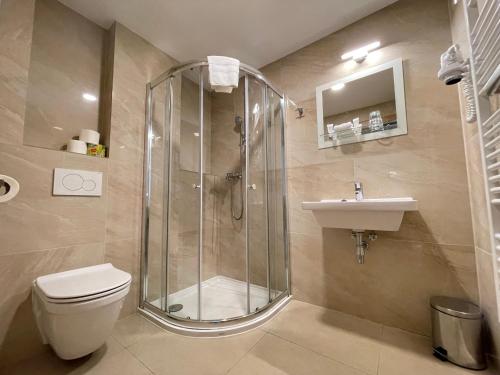 a bathroom with a shower and a toilet and a sink at Tatraline Jasna in Liptovský Mikuláš