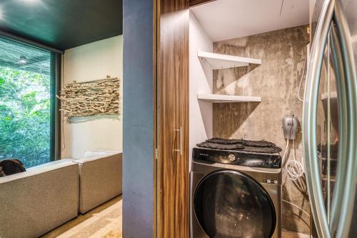 a kitchen with a washing machine in a room at Divine 2BR Tulum on Cenote Gym - Xalet E104 in Tulum