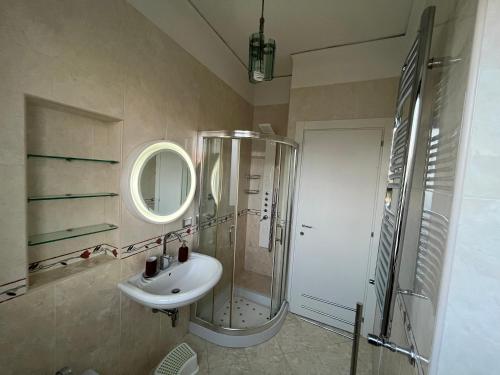 a bathroom with a sink and a shower and a mirror at Balcony House in Naples