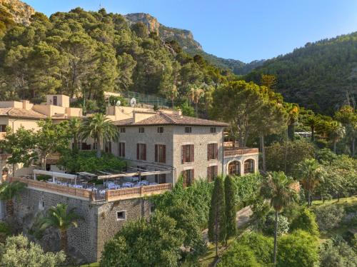 an aerial view of a house with palm trees at Es Moli Hotel in Deia