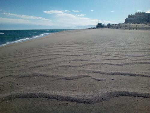 a beach with a heart drawn in the sand at Appartement 3 pièces front de mer in Le Barcarès