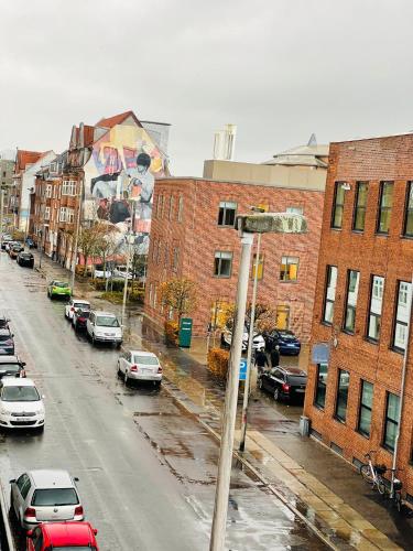 a city street with cars parked on the street at Scandinavian Apartment Hotel - Sønderbro - Central 2 room apartment in Horsens