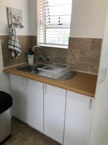 a kitchen counter with a sink and a window at Shearwater 106 in Sedgefield