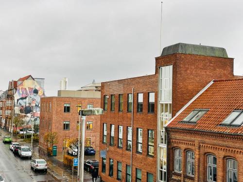 a group of brick buildings on a city street at Scandinavian Apartment Hotel - Sønderbro - Central 2 room apartment in Horsens
