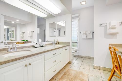 a bathroom with two sinks and a large mirror at Makanui at Poipu Resort 222 in Koloa