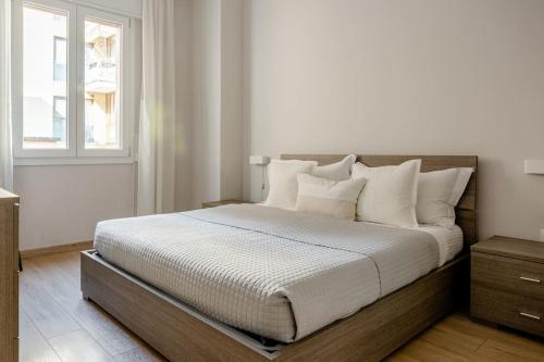 um quarto branco com uma cama grande e almofadas brancas em Centro Storico - Stazione a 500m Strategico Elegant Loft em Pádua