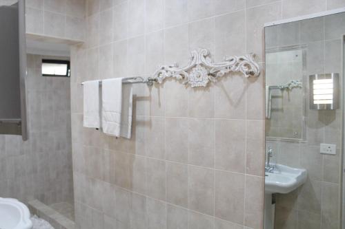 a bathroom with a shower and a sink and a toilet at La Dolce Vita Umhlanga Guesthouse in Durban