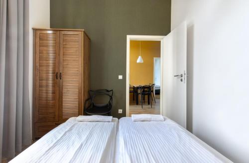 a bedroom with two beds and a dining room at Atlantis Hostel in Kraków