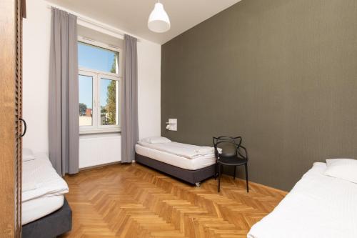 a room with two beds and a window at Atlantis Hostel in Kraków