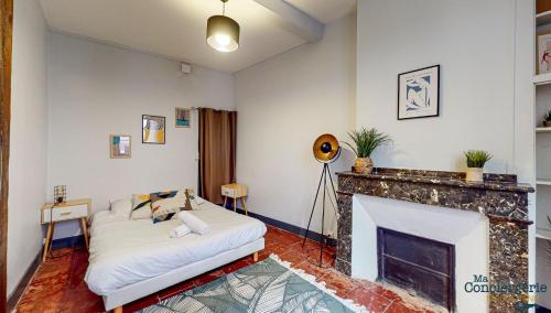 - un salon avec un lit et une cheminée dans l'établissement COUTELIERS - Hypercentre Carmes - Métro à 4min, à Toulouse