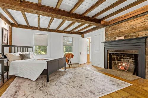 a bedroom with a bed and a fireplace at The Wolfstead - near Mystic, Casinos & Beaches in Stonington