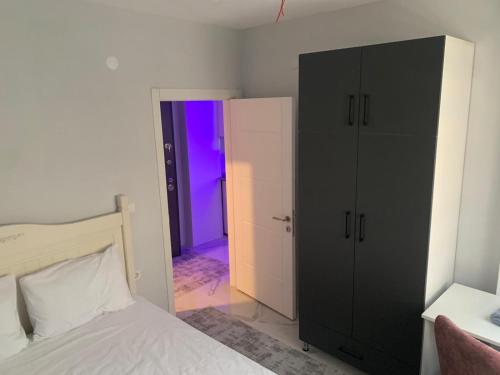 a bedroom with a black cabinet and a purple door at Fatih apart otel in Bostancı