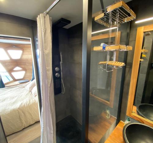 a shower in a tiny house with a bed at White Paradise in Val-d'Isère