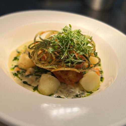a white plate topped with a dish of food at The Beresford Arms in Morpeth