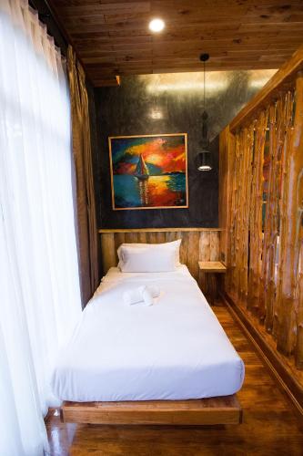 a bedroom with a white bed in a room at Andalay Beach Resort Koh Libong in Ko Libong