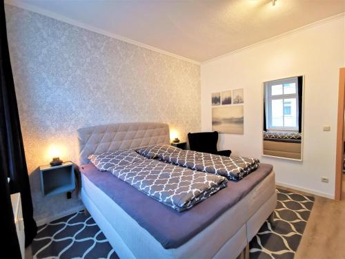 a bedroom with a large bed in a room at Apartment "Matt Rose" Rostock in Rostock
