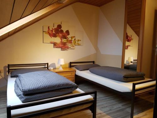 two twin beds in a room with a staircase at Ferienhaus Bauer in Zirndorf