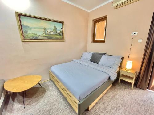 Dormitorio pequeño con cama y mesa en Apartment Centar, en Podgorica