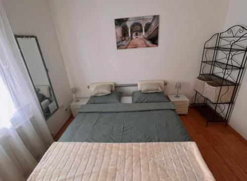 a small bedroom with two beds and a mirror at Home Away From Home - New Cosy Apartment Kruge in Zagreb